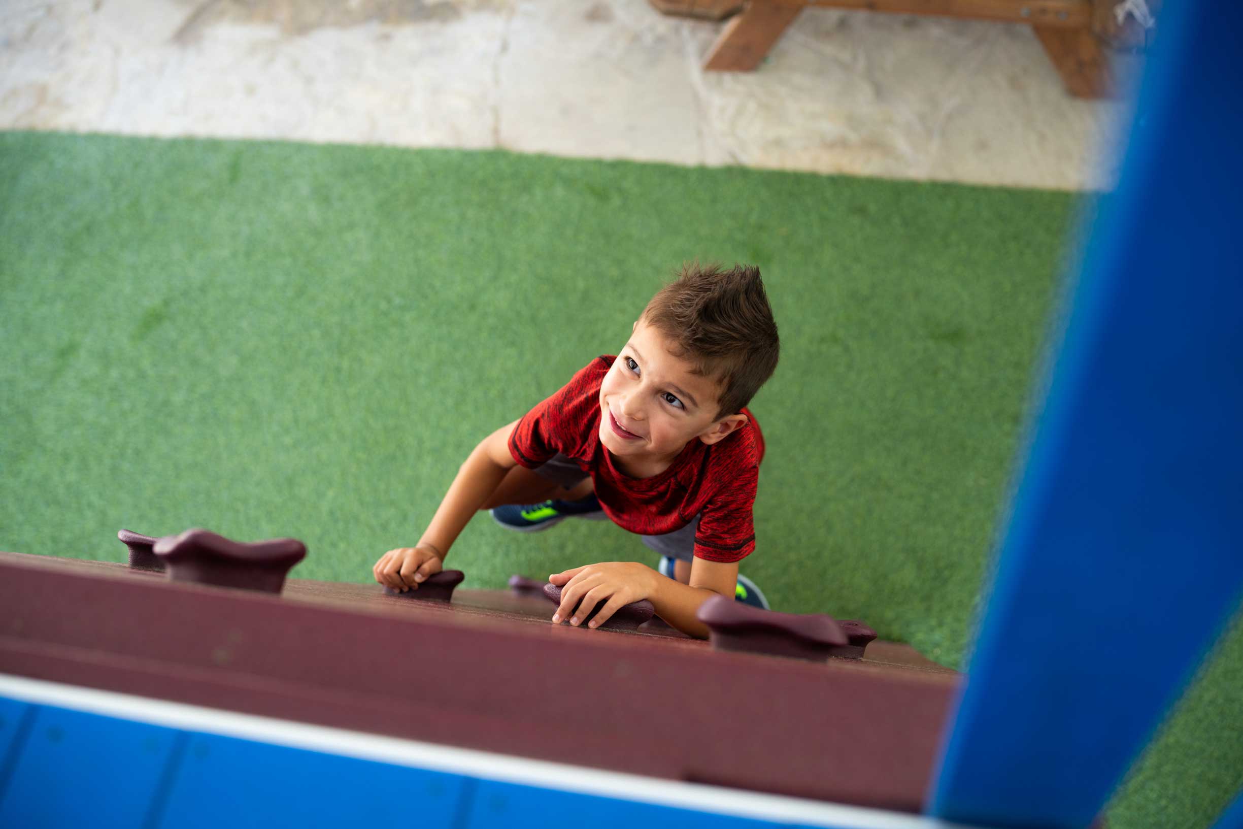 little boy playing in playscape